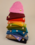 A colorful stack of Ribbed Beanies