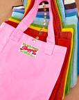 Shopper Tote Bag stacked on top of one another in a rainbow of hues