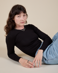 Alex is wearing Long Sleeve Baby Tee in Basic Black