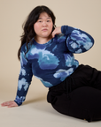 Ashley is wearing Long Sleeve Baby Tee in Blue Magic Waters