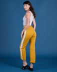 Angled back view of Painted Work Pants in Mustard Yellow on Alex