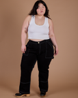 Ashley is 5’7” and wearing 1XL Carpenter Jeans in Black paired with a vintage tee white Cropped Tank