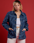 Tiara is 5’4” and wearing S Chain Link Work Jacket paired with a white cami underneath and white work pants