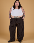 Sam is 5'10" and wearing 2XL Corduroy Drop Pocket Cargo Pants in Espresso Brown paired with a Cropped Tank in Vintage Tee White