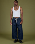 Isaac is 5’10” and wearing M Denim Drop Pocket Pants in Dark Wash paired with vintage tee white Cropped Tank