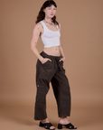 Alex is 5’8” and wearing XXS Drop Pocket Cargo Pants in Espresso Brown paired with a vintage tee white Cropped Tank