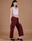 Alex is 5’8” and wearing XXS Drop Pocket Cargo Pants in Red Wine paired with vintage tee white Cropped Tank