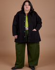 Sam is 5'10" and wearing 2XL Ripstop Field Coat in Basic Black paired with evergreen Drop Pocket Cargo Pants