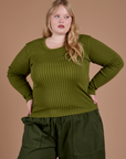 Juliet is 5’7” and wearing L Gingham Long Sleeve Baby Tee in Summer Olive