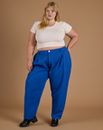 Juliet is 5’7” and wearing 2XL Heritage Trousers in Royal Blue paired with vintage off white Cropped Baby Tee