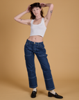 Alex is 5’8” and wearing XS Mid-Rise Carpenter Jeans in Dark Wash