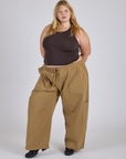Juliet is 5’7” and wearing 2XL Drop Pocket Cargo Pants in Desert Brown paired with espresso brown Racerback Tank