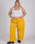 Juliet is 5’7” and wearing 2XL Drop Pocket Cargo Pants in Sunshine Yellow paired with a Cropped Tank in Vintage Tee White