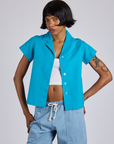 Kira is 5’10” and wearing P Pantry Button-Up in Hawaiian Blue