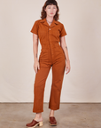 Alex is 5'8" and wearing XS Short Sleeve Jumpsuit in Burnt Terracotta