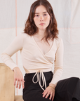 Hana is 5'3" and wearing size 1 Wrap Top in Vintage Tee Off-White
