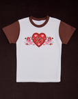 White body with fudgesicle brown sleeves and neckline. Large red heart with black inner outline and pink hearts. Big Bud text in center of red heart. Two pink cupids with red hair are pointing arrows to the heart.