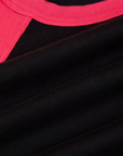 Fabric close up of the Black/Pink Colorblock Raglan Tee