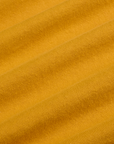 Painted Burly Tee in Mustard Yellow fabric detail close up