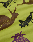 Paintstamped Pantry Button-Up in Big Bug close up. Gross Green with brown, black and purple stamped bugs