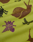Paintstamped Work Pants in Froggy fabric close up of brown, black and purple bugs