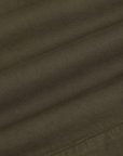 Pleated Trouser Shorts in Surplus Green fabric detail close up