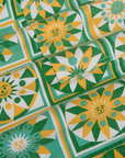 Longline Work Shorts in Spring Quilt Print fabric detail close up. Sun quilt print in green, yellow and white.