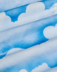 Work Pants in Sunny Cloud Airbrush fabric detail close up. Airbrushed blue skies with white clouds