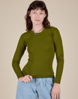 Alex is 5’8” and wearing P Long Sleeve Baby Tee in Summer Olive