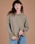 Alex is 5’8” and wearing P Long Sleeve Burly Tee in Khaki Grey