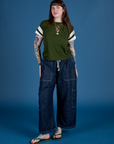 Sydney is wearing Painted Vintage Tee in Evergreen and dark wash Drop Pocket Cargo Pants