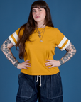 Sydney is 5’9” and wearing XXS Painted Burly Tee in Mustard Yellow