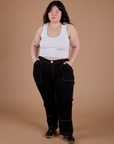Ashley is wearing Carpenter Jeans in Black and Cropped Tank in Vintage Tee White