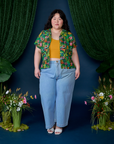Ashley is wearing Pond Party Pantry Button-Up paired with light wash Indigo Wide Leg Trousers