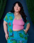 Ashley is wearing Paintstamped Pantry Button-Up in Lilypad with a bubblegum pink Cami underneath