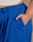 Close up of Juliet's hand in the front pocket of Heritage Trousers in Royal Blue