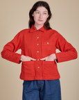 Alex is 5'8" and wearing P Denim Work Jacket in Mustang Red