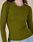 Long Sleeve Baby Tee in Summer Olive front close up on Alex