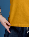 Painted Burly Tee in Mustard Yellow front bottom close up on Sydney