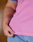 Close up of Juliet holding the bottom hem of Calypso Tee in Bubblegum Multi