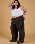 Angled front view of Corduroy Drop Pocket Cargo Pants in Espresso Brown and Cropped Tank in Vintage Tee White on Sam