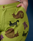 Close up of Ashley's hand in the front pocket of Paintstamped Work Pants in Froggy