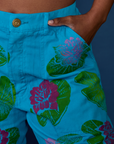 Close up of Kandia's hand in the front pocket of Paintstamped Work Pants in Lilypad