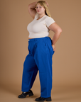 Side view of Heritage Trousers in Royal Blue and Organic Vintage Tee in Vintage Off White on Juliet