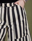 Close up of Sydney's hand in the front pocket of Longline Work Shorts in Natural
