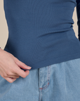 Long Sleeve Baby Tee in French Blue bottom hem close up on Alex