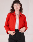 Alex is wearing Mechanic Jacket in Mustang Red