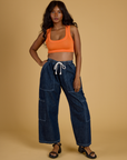 Kandia is wearing Contrast Stitch Mini Tank in Construction Orange and dark wash Denim Drop Pocket Pants