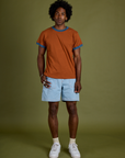 Jerrod is wearing Vintage Ringer Tee in Burnt Terracotta and light wash Carpenter Shorts
