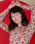 Long Sleeve Baby Tee in Hot Stuff Print front close up on Alex